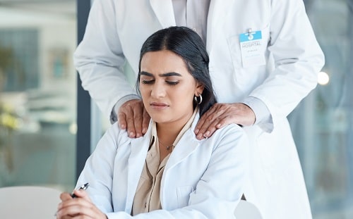 Man touching Woman's Shoulders iStock PeopleImages