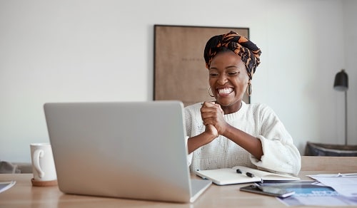 Happy Woman at Laptop iStock LaylaBird